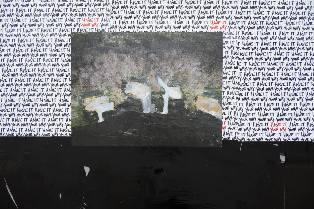 Colour Photograph of photo montage art pasted up on a black wall with white paper and the words "have it your way" repeated in the background.