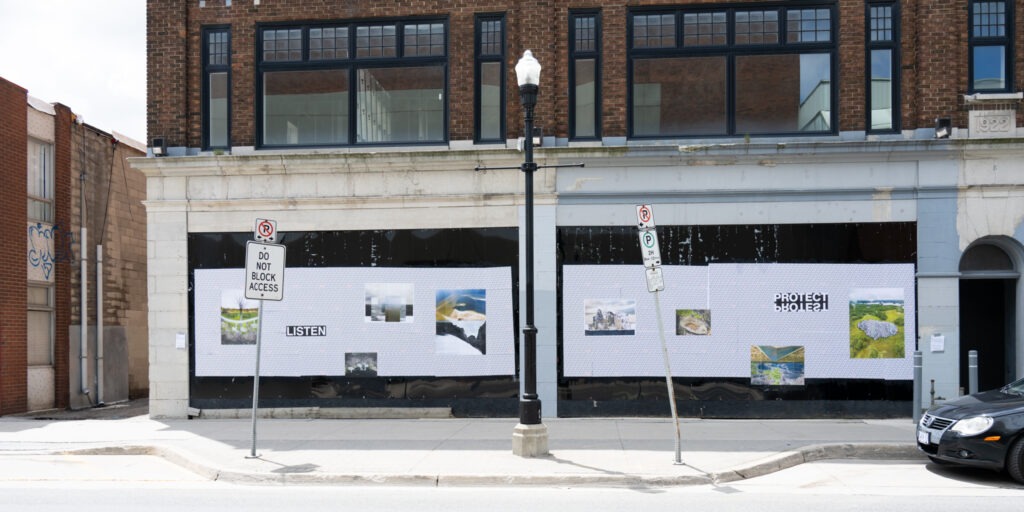 Colour photograph of art glued onto billboard space at street level on the front of an abandoned building.